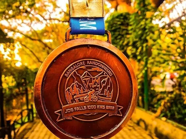 The Bangalore Randonneurs medal for the Jog Falls 1000 km BRM, hanging in autumn light.